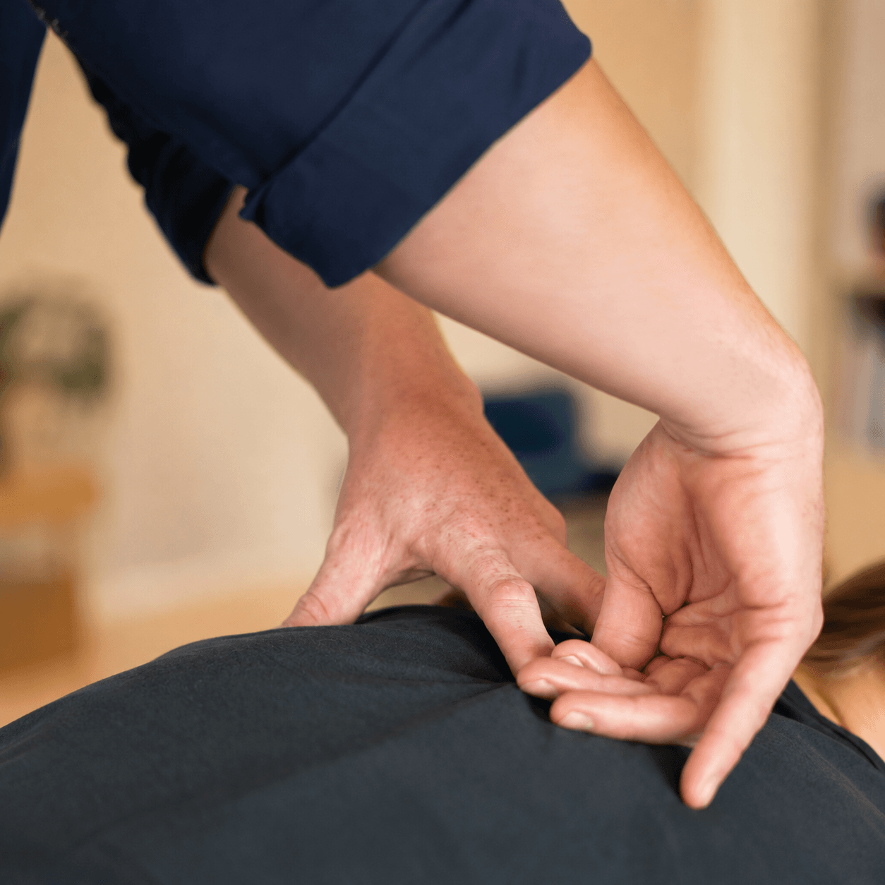 Matthew Yeates performing a hands-on spinal palpation assessment